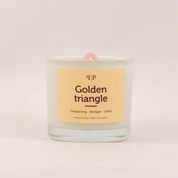 Gemstone scented candle with a golden triangle design, featuring a warm, earthy fragrance.