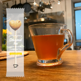  Lemon ginger tea-pop sticks in a box of 30, without packaging or trays. The tea is served in a glass mug, showing the amber-colored liquid.