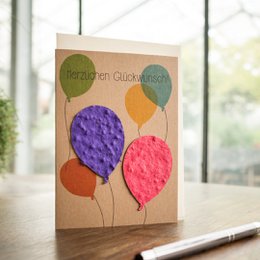 Colorful greeting card with balloons in various shapes and shades, perfect for celebrating a birthday or congratulating someone.