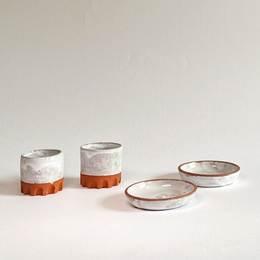 Small, round ceramic bowls in white and orange colors. Suitable for serving snacks, dips, or as decorative pieces.