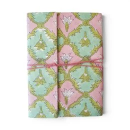 Notebook covered with violet printed fabric featuring floral patterns and designs.
The notebook is covered in a violet-colored printed fabric with a floral pattern. The design includes stylized flowers and leaves in shades of purple, blue, and pink. The fabric has a textured, embroidered-like appearance, adding visual interest to the notebook cover.