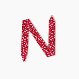 Red and white polka dot patterned bracelet with a feminine, stylish design.