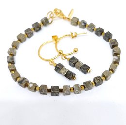 The product is a bracelet and earring set made with beaded stones in various colors, including pyrite, fossil, crazy lace, and rhodonite. The bracelet features square-shaped beads in a neutral color palette, likely to complement a variety of outfits. The earrings match the bracelet, creating a cohesive jewelry set.