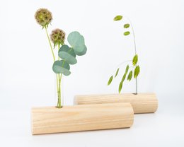 Tall, cylindrical vase made of violet-colored ashwood with dried floral stems in a natural, minimalist design.