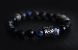 Black and blue beaded bracelet with a metal accent bead.