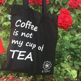 Black tote bag with text "Coffee is not my cup of TEA"