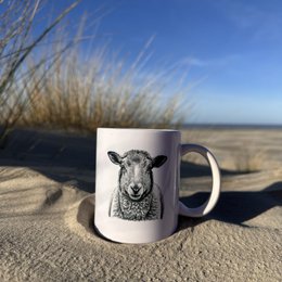 A white ceramic mug featuring a detailed illustration of a starfish against a blue background, surrounded by seashells and other beach elements.