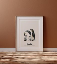 A framed wall art print featuring a family of penguins with the French word "famille" (family) below. The image showcases a minimalist, black and white design style.