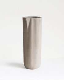 Tall, cylindrical white ceramic vase with vertical ribbed texture, suitable for displaying dried or fresh flowers.