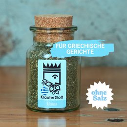 Herbal mixture Hellas, a seasoning product in a glass jar. The product is described as ideal for Greek cuisine, containing a blend of herbs and spices. The image shows the product jar with a label featuring a crown-like design.