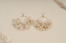 Elegant statement earrings featuring a delicate floral design with pearl accents.