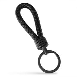 A braided leather keychain in various colors including black, brown, blue, gray, green, beige, red, turquoise, purple, and pink. The keychain features a sturdy metal ring for attaching keys or other small items.