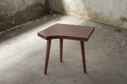 Wooden side table with a hexagonal top and tapered legs in a dark brown finish.