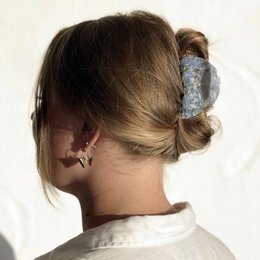Ice blue claw clip with feather-like design, suitable for casual or formal hairstyles.
