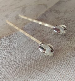 Two silver-colored hair pins with diamante accents.