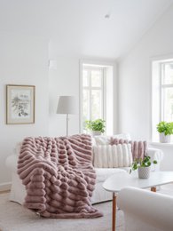 Soft, plush taupe-colored throw blanket with a textured, wavy pattern. Made of high-quality materials for a cozy and comfortable feel.