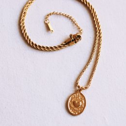 Twisted steel chain with an oval heart charm