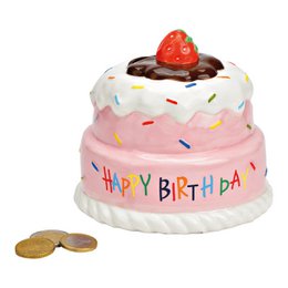  A round, tiered cake with a pink frosting base, topped with a strawberry and chocolate drizzle. The cake is decorated with colorful sprinkles and has "Happy Birthday" written on it. The cake appears to be made of ceramic or a similar material and is a decorative money box or savings bank.