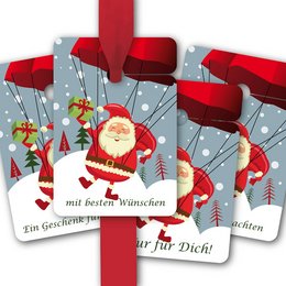 Red and white gift tags with a flying Santa Claus design, featuring text in German that translates to "Just for you" and "Only for you!". The tags have a festive winter scene with trees, snowflakes, and a parachuting Santa.