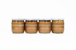 A starter box of peanut butter jars from The Peanut Butter Shop. The jars contain smooth, creamy peanut butter in a variety of flavors.