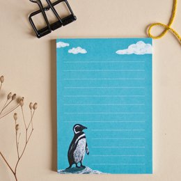 A7 notepad with a penguin illustration on a blue sky background. The notepad is suitable for writing, journaling, or note-taking.