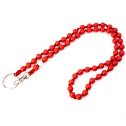 A vibrant red beaded keychain with a silver clasp, featuring a long, rounded shape reminiscent of a watermelon.