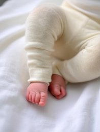 Woolen baby pants made from soft, natural merino wool in a neutral beige color. Comfortable and durable for active infants and toddlers.