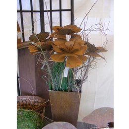Vintage decorative metal flower plug, featuring a rustic, patina-finished metal flower sculpture in a natural, earthy color palette. Suitable for garden or indoor decor.