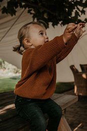 Rust-colored knit baby sweater, available in sizes 3-6M to 4Y. Cozy, warm, and stylish for infants and toddlers.