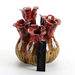 A decorative vase with a unique, textured surface in shades of red and brown. The vase has an organic, sculptural shape with multiple openings or "flowers" protruding from the main body.