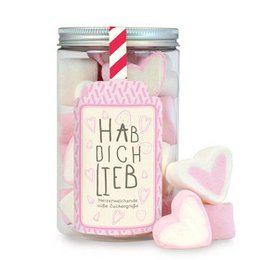 Soft, fluffy marshmallows in a glass jar with a pink and white striped label that reads "Hab dich lieb", which means "I love you" in German. The marshmallows are heart-shaped and come in various pastel colors, creating a sweet and romantic display.