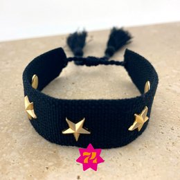  A black woven bracelet with gold star accents and a pink flower charm.