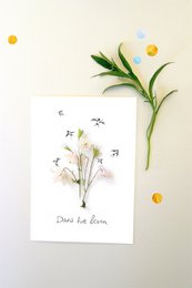 A deck of cards featuring a nature-inspired design with a floral motif. The cards have a minimalist, botanical aesthetic with delicate illustrations of flowers and leaves.