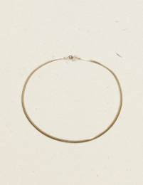 Gold-toned charm necklace with a simple, minimalist design.