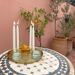 Brass centerpiece tray with candle holders, featuring a mosaic tile pattern and white candles.