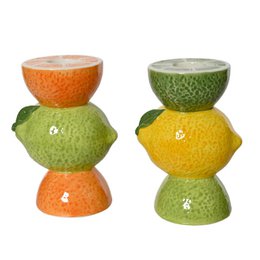  A set of colorful candlestick holders made from various citrus fruits, including lemons, limes, and oranges. The holders have a unique stacked design and appear to be made of ceramic or a similar material.