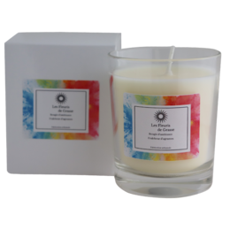 A tall, round, white candle with a citrus scent. The candle is packaged in a white box with colorful floral accents.