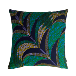 Decorative cushion with abstract geometric pattern in shades of green, navy, and gold.