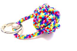 Colorful paracord keychain with a ship button design, featuring a variety of vibrant colors including red, blue, yellow, and green.