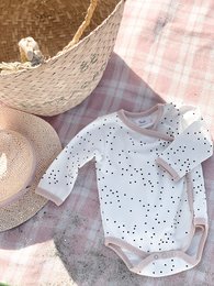 White baby romper with polka dot pattern, suitable for infants aged 3-12 months.