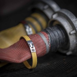 Leather charm bracelet with a metal clasp in a bold, rectangular shape.