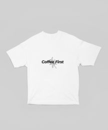  Oversized white t-shirt with "Coffee First" text printed in black. Relaxed, casual style suitable for everyday wear.