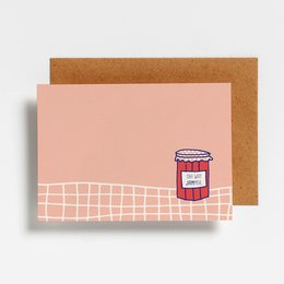 A postcard with a red circular design and a pink background, featuring a simple, minimalist style.