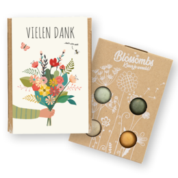  A small gift box containing 4 seed bombs in a variety of colors, perfect for planting and growing a colorful garden. The box features a floral design and the text "Thank you" in German.