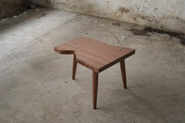 Rectangular wooden side table with tapered legs in a minimalist, modern design.