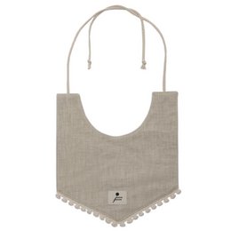Decorative beige bib with BOHO LEO design and pom pom trim. Made of linen material, suitable for babies and toddlers.