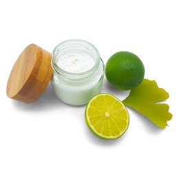 Ginkgo lime deodorant cream in a glass jar, with a lime and ginkgo leaves visible. The product appears to be a natural, plant-based deodorant.