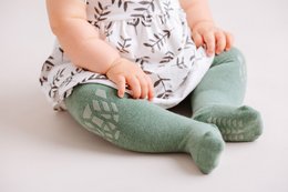 Soft, cozy baby crawling tights in a forest-themed pattern. Made with comfortable, stretchy material for easy movement. Available in sizes 6-12 months and 12-18 months.