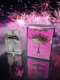 A floral, feminine perfume in a pink bottle with an Eiffel Tower design, evoking the romantic charm of Paris.
