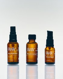 Intimacy Essentials Box containing massage oils in amber glass bottles with black caps. Includes essential oils for relaxation and sensual massage.